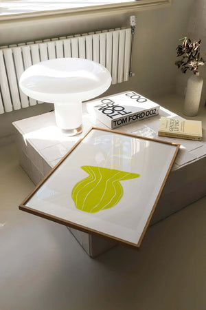 Plakat med grøn organisk form og fine linjer på lys baggrund i moderne indretning