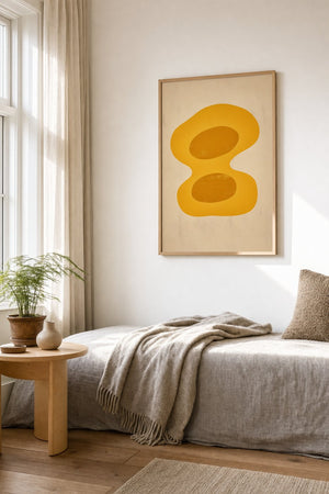 Gul organisk form plakat i egetræsramme over sofa i stue